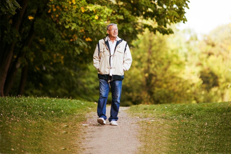 elderly man out walking in the park