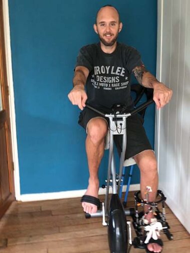 tom on an exercise bike