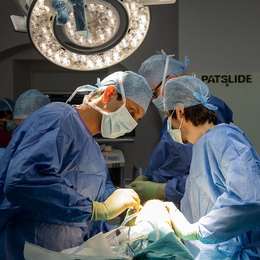 three surgeons operating