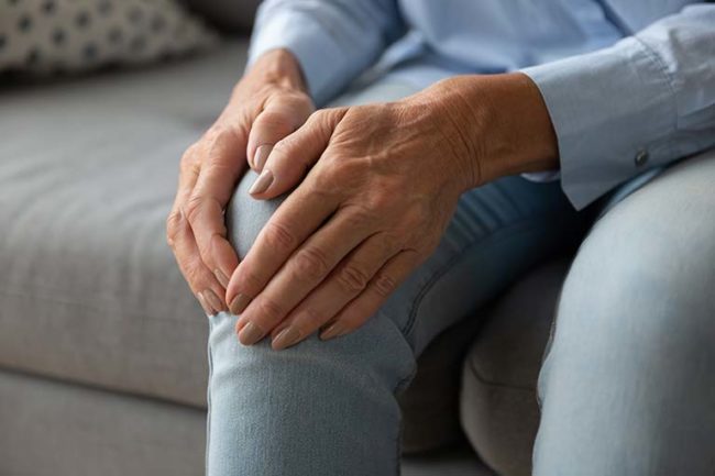 Woman holding her knee osteoarthritis